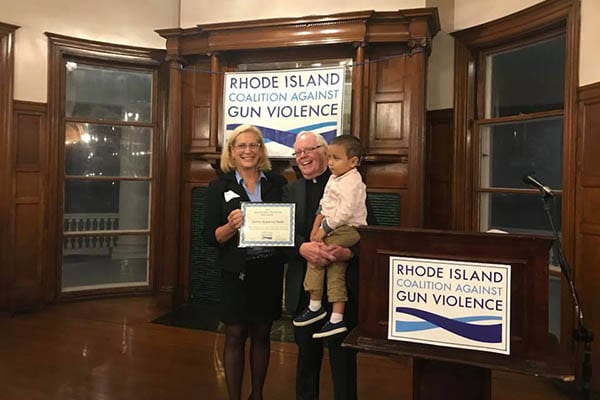 Father Ray Malm accepts the Gun Violence Prevention Impact Award from RICAGV 2018